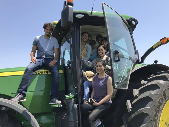 research scholars on a tractor