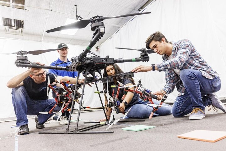 scholars working on a drone